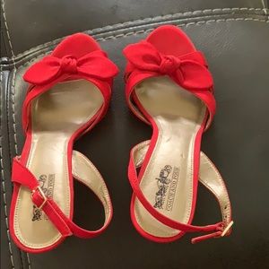 Super cute red coach and four heels